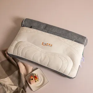 Close-up detail showing the texture and embroidered logo of a grey cervical pillow