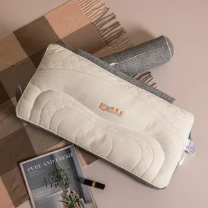 Close-up detail of a grey and cream quilted neck pillow set with detachable bolster.