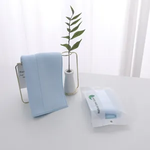 Soft light blue natural latex face towel with matte retail packaging