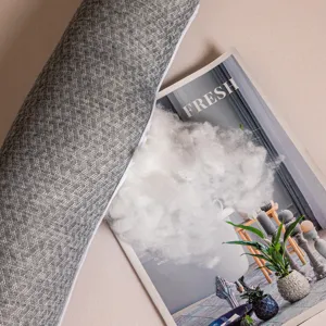 Close-up of fluffy white fiber filling inside a grey textured detachable pillowcase