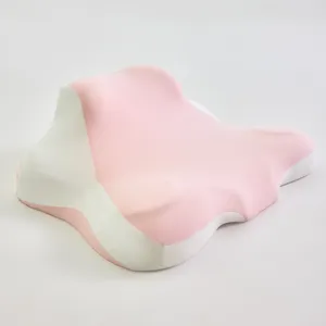Almohada ergonómica multiusos rosa y blanca para apoyo de cuello y hombros en casa