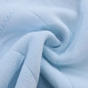 Soft light blue latex face towel showing detailed plush texture for skin care.