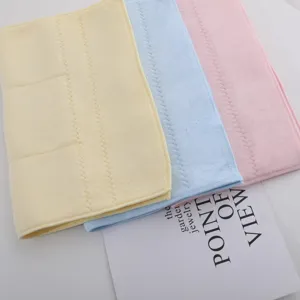 Close-up showing the soft texture of yellow, blue and pink latex microfiber face towels