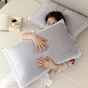 Elegant grey pillow with white lace trim and gold Bohe embroidery for bedroom decor