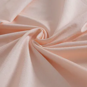 Detailed macro texture of light pink cooling ice silk fabric for elastic pillowcases