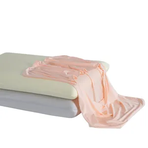 Premium solid pink cooling ice silk pillowcase draped over memory foam pillows for summer