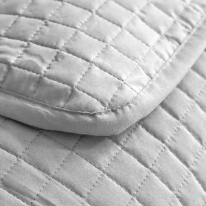 Grey quilted pillow protector with refined stitching for sweat and oil protection