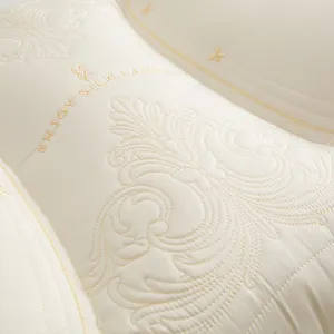 Detailed close-up showing elegant golden butterfly embroidery on luxury cream Tencel latex pillow