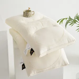 Detail shot of premium latex pillows featuring elegant 3D embroidery and silk labels