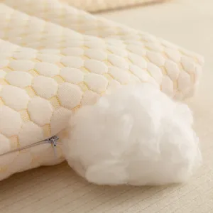Close-up of a washable fiber pillow core showing quilted honeycomb texture and filling.