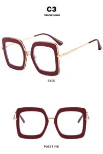 Burgundy oversized square eyeglass frames with gold metal temples and blue light lenses.