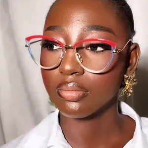 Close-up detail of stylish two-tone red and clear cat-eye glasses frame on a model