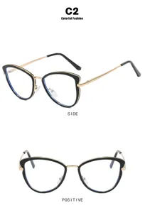 Detail view showing front and side of black and gold cat-eye glasses frames.