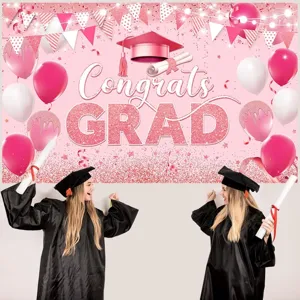 Pink graduation party backdrop featuring Congrats GRAD glitter text and balloons