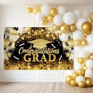 Black and gold graduation party backdrop with Congrats Grad text and balloon arch decoration
