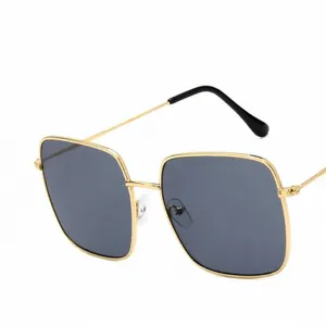 Stylish oversized square metal sunglasses with a retro polygonal frame and gold temples