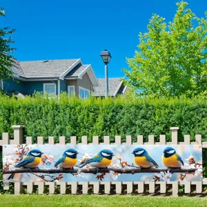 Decorative garden banner with blue tit bird and blossom print displayed on a wooden fence.