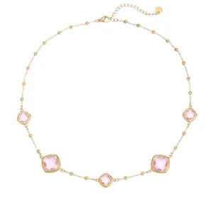 Exquisite detail of a gold stainless steel necklace featuring pink square-cut crystals