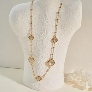 Close-up of elegant gold stainless steel necklace with clear crystal charms