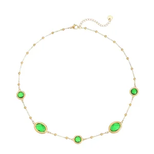Stainless steel clavicle chain featuring green gemstones with gold bezel bead chain detail