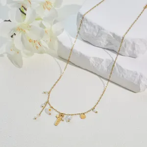 Close-up of gold stainless steel necklace with daisy, heart, and 'LOVE' engraved charms