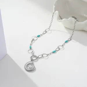 Macro view of stainless steel marine necklace with conch pendant and turquoise beads