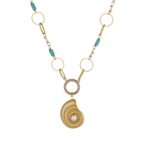 Detailed view of ocean style necklace with gold conch pendant pearl and turquoise beads