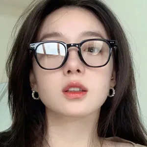 Close-up of stylish black frame glasses worn by a female model in Korean fashion style