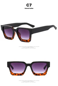 Detail view of retro square sunglasses with black and tortoiseshell frames and purple lenses