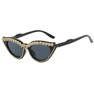 Fashion cat-eye sunglasses with sparkling rhinestone embellishments for party wear.