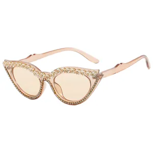 Trendy rhinestone cat-eye sunglasses with peach translucent frames and sparkling crystals.