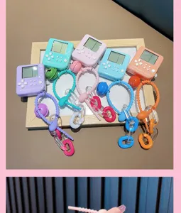 Close-up of colorful mini handheld game console keychains in five pastel colors