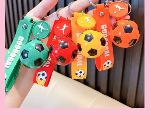 Close-up view of colorful 3D football keychains featuring GOOOOAL straps and charms.