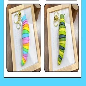 Detail view of colorful and green jointed caterpillar stress relief keychains in frames
