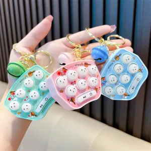 Portable mini whack-a-mole electronic game keychain set in pink blue and green