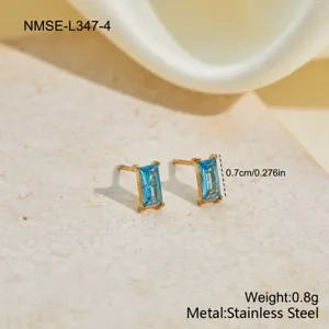Macro view of blue rectangular zircon stud earrings in gold-tone stainless steel finish