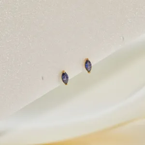 Close-up detail of marquise-cut purple zircon stud earrings in gold stainless steel