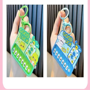 Close-up of mini electronic piano keychains in green and blue