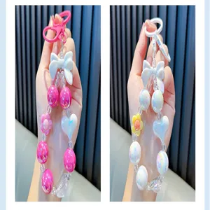 Close-up detail of creative colorful acrylic beaded keychain with bow and heart charms