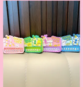 Close-up of four colorful mini electronic piano keychains with cute cartoon themes