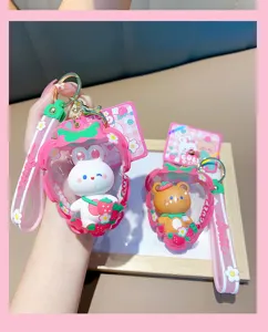 Close-up of cute rabbit and bear strawberry-shaped inflatable bag keychains