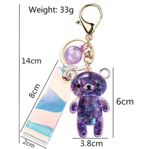 Cute purple acrylic bear keychain featuring glitter sequins and an iridescent strap accessory