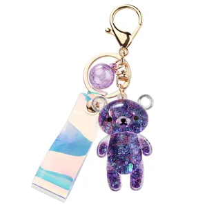Glittery purple acrylic bear keychain with holographic strap and gold keyring pendant