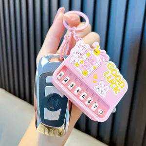 Pink mini piano keychain toy with cute bunny illustration and Good Luck text decoration