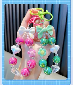 Detailed view of creative acrylic colorful beaded keychains with bow and heart accents