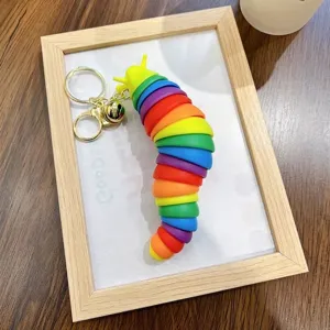 Rainbow segmented slug fidget toy keychain with gold bell and ring accessory for bags