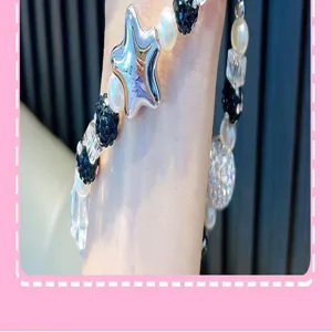 Detail close-up of a star-shaped silver bead and black crystal beaded strap keychain.