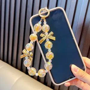 Ciondolo per cellulare in perle di cristallo con fiocco dorato borsa accessori chic