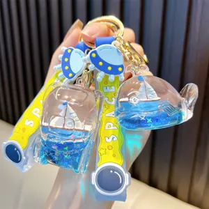 Kreativer blauer Treibsand-Schlüsselanhänger mit Segelschiff in Wal-Flasche