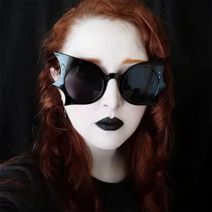 Detailed close-up of stylish black bat-shaped sunglasses for a spooky Halloween costume look
